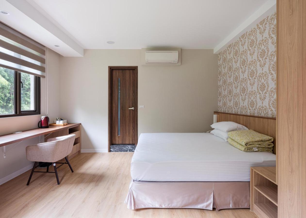 名竹旅社 Minzu Hotel لوغو المظهر الخارجي الصورة